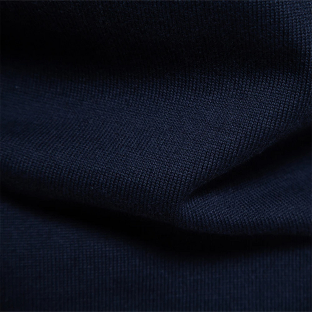 Men's dark knit polo sweater fabric close-up showing ribbed hem fold