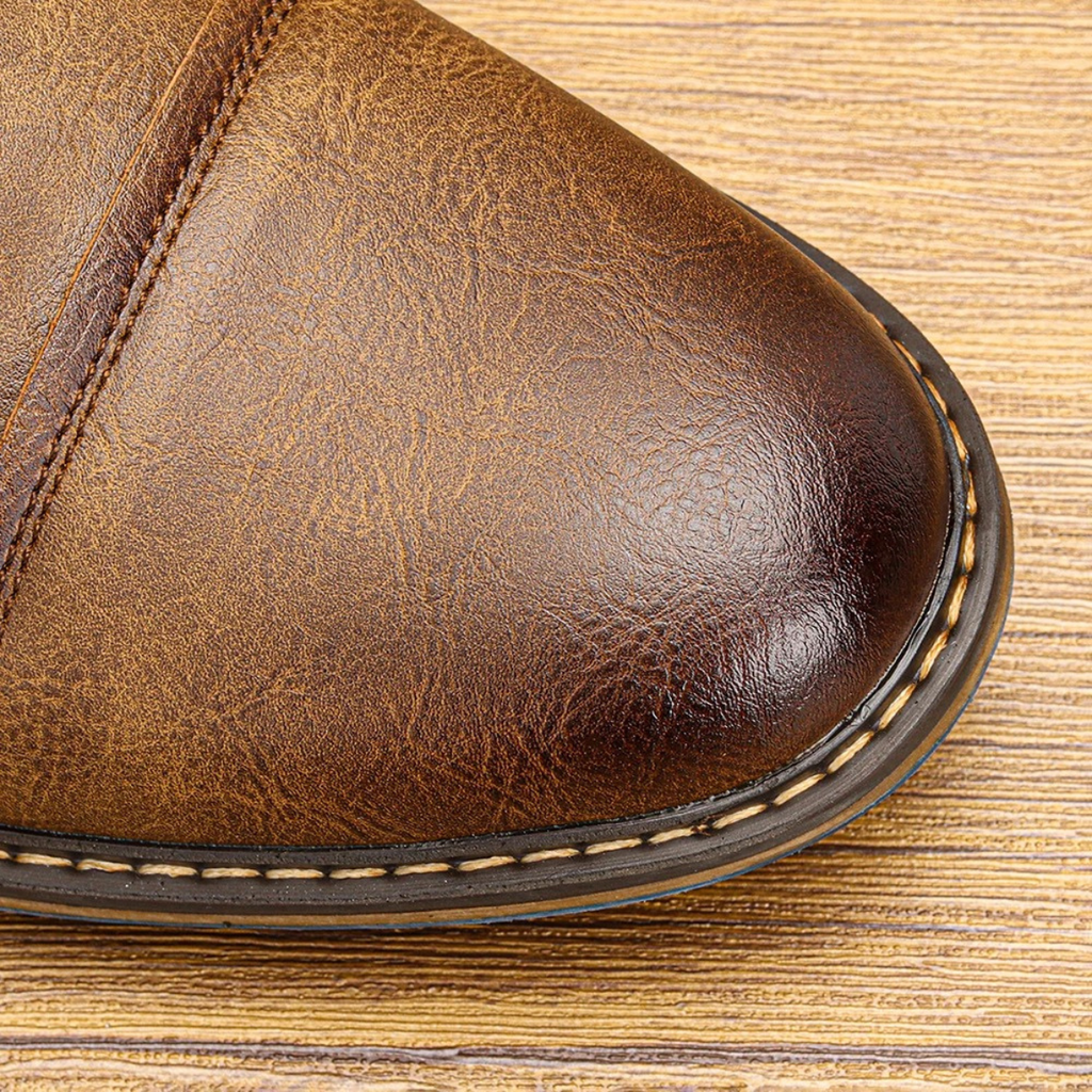 Brown leather oxford shoe toe cap close-up with stitched edge