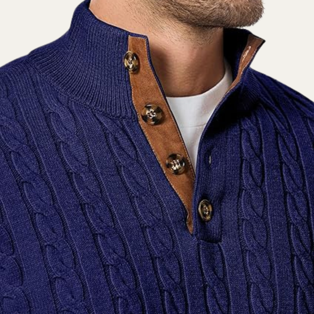 Navy cable-knit sweater collar with brown leather placket and round metal buttons