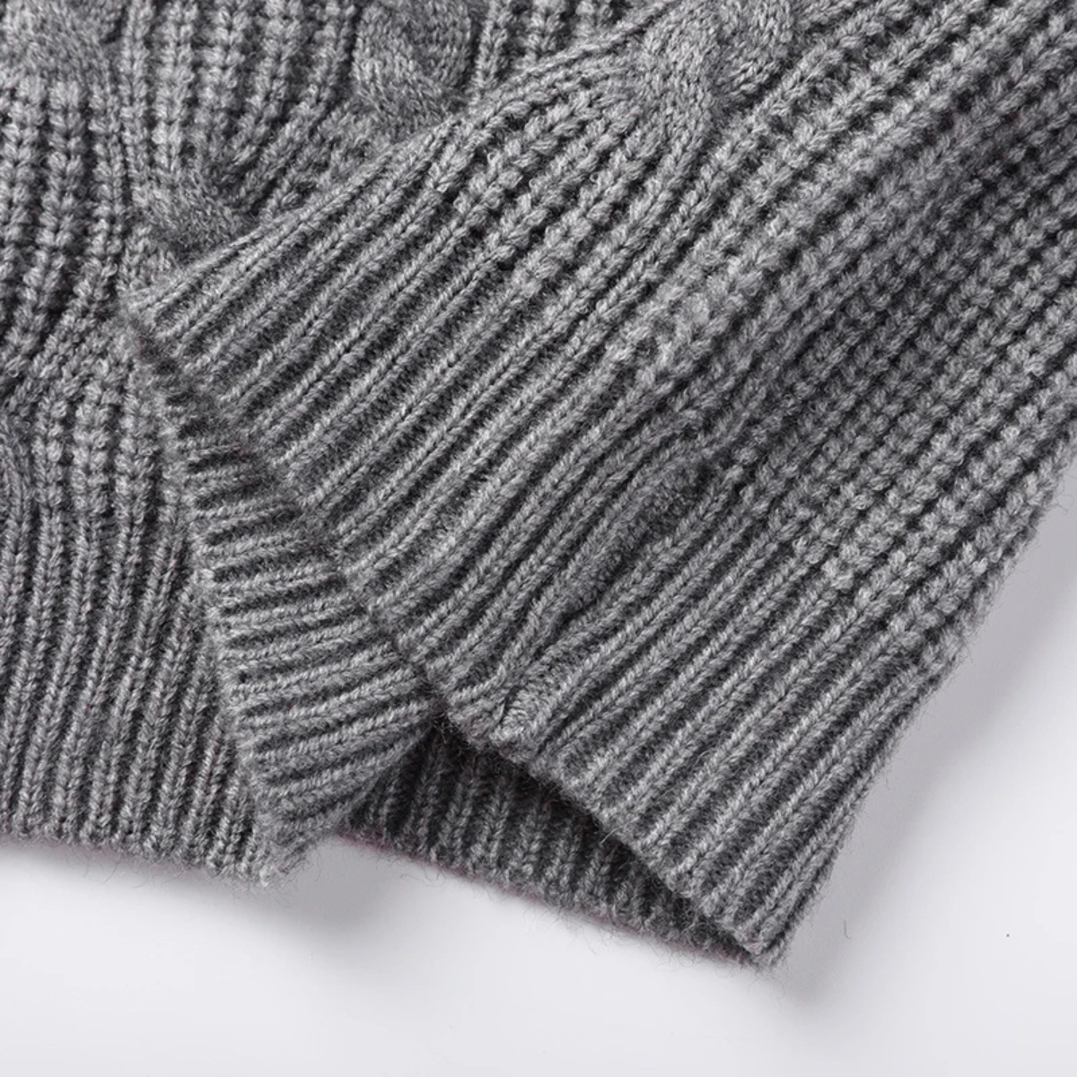 Men's gray textured knit V-neck sweater vest close-up of ribbed cuffs and stitch pattern