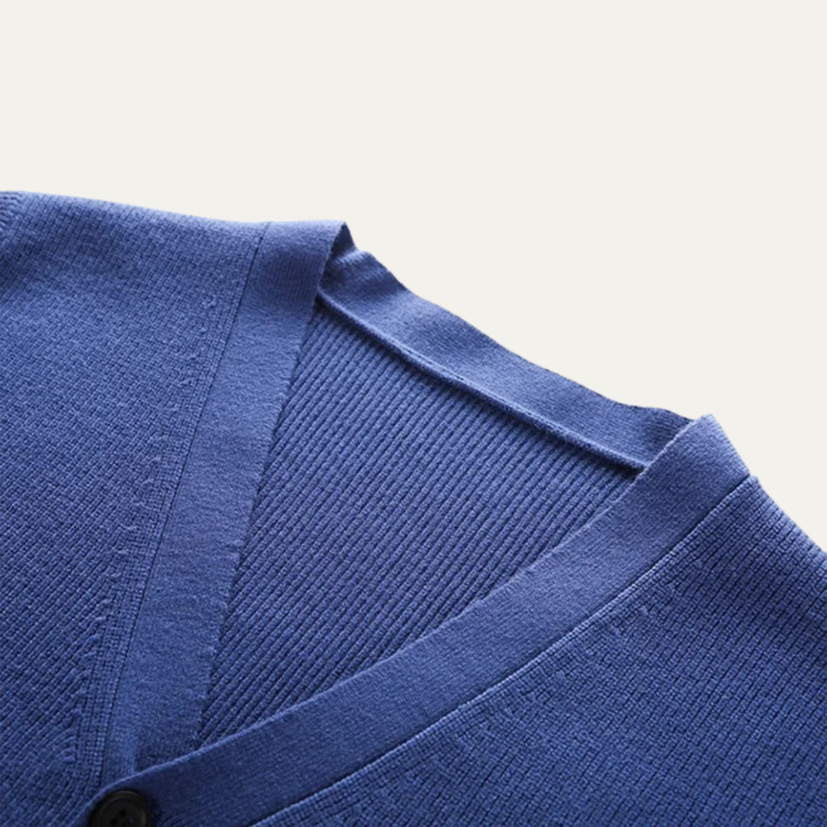 Close-up of men's blue V-neck sweater vest knit and button placket