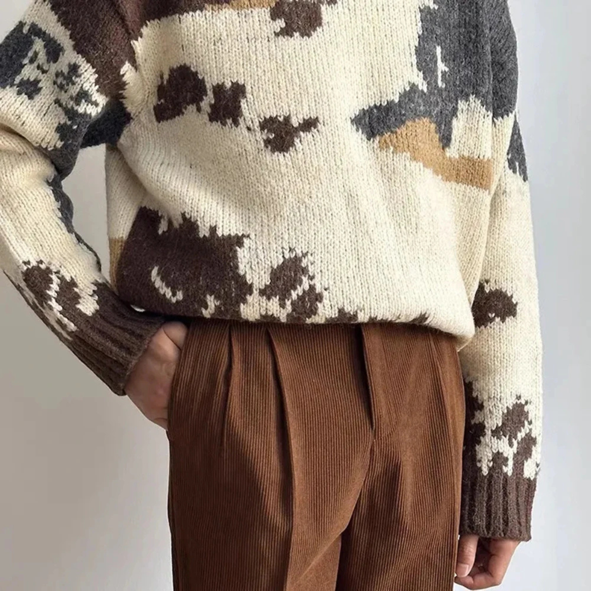 Brown corduroy high-waisted pleated pants with pleats at front and belt loops