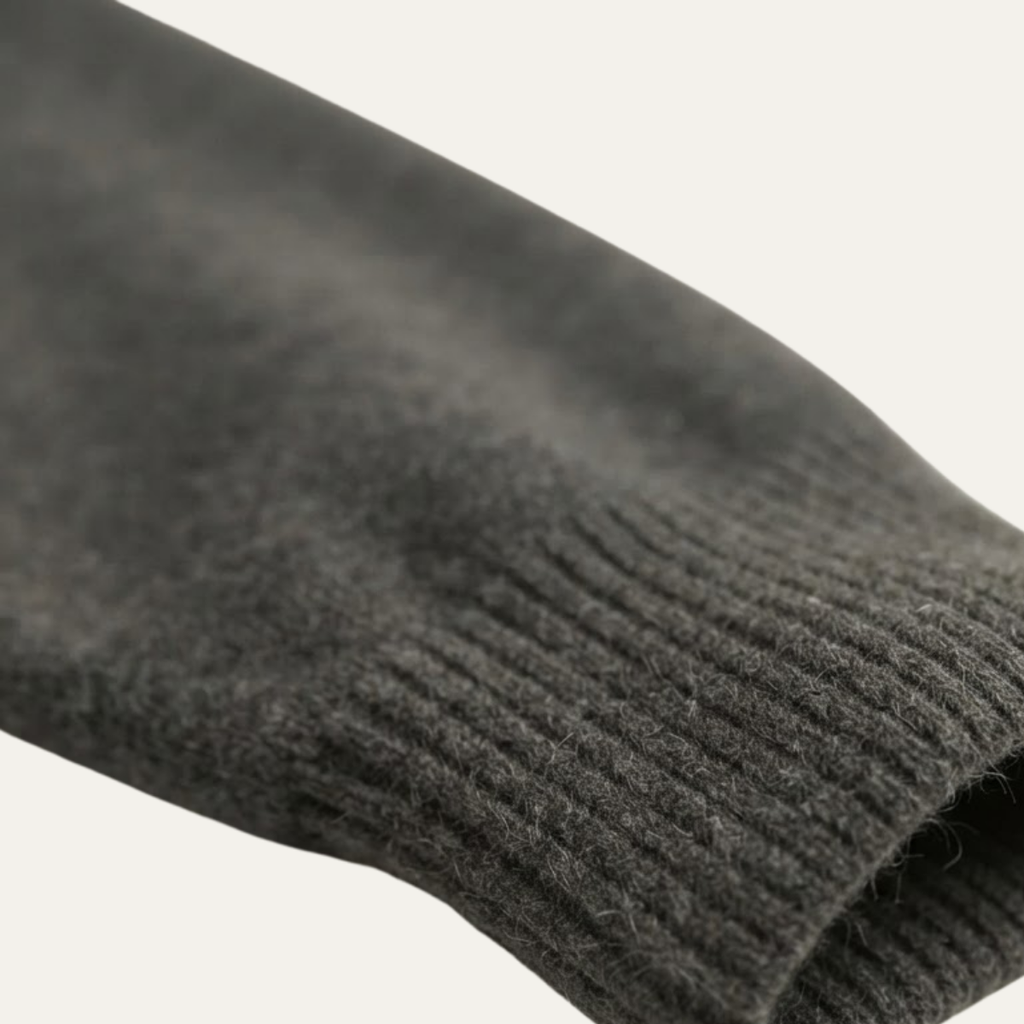 Lightweight knit sweater fabric close-up in dark gray