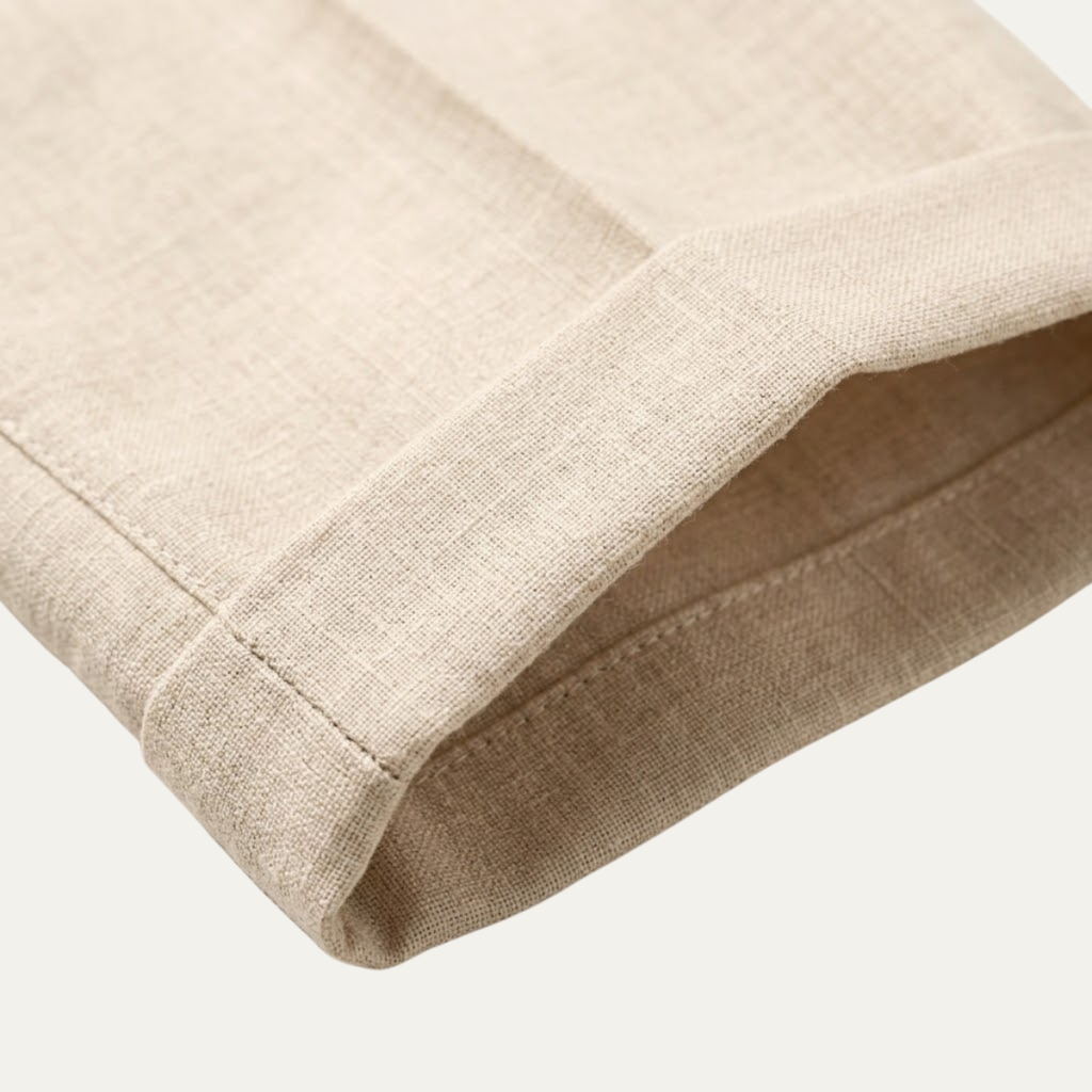 Light beige linen dress pants hem detail with stitched cuff and textured weave.