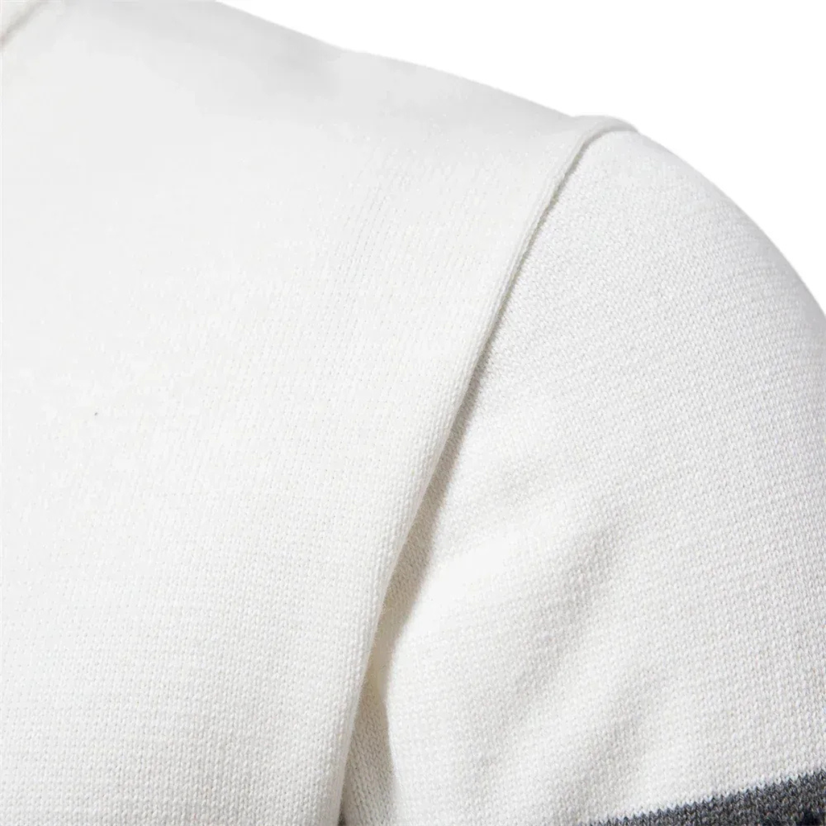 White knit quarter-zip cotton sweater, textured fabric detail at shoulder and sleeve