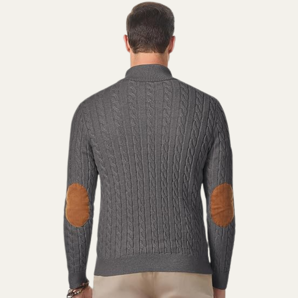 Men's dark gray cable-knit sweater back with tan elbow patches and ribbed hem