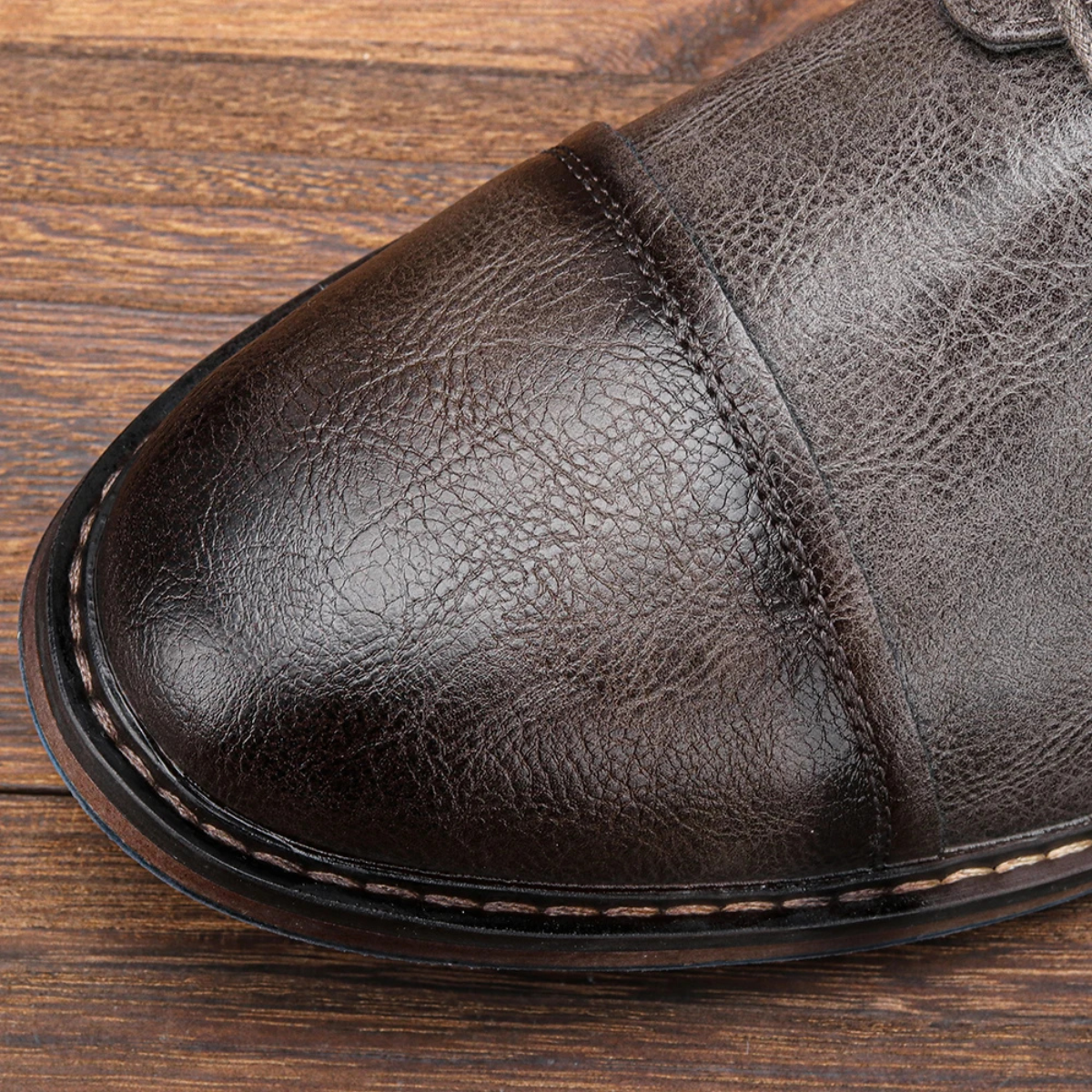 Men's leather Oxford shoe toe, dark brown textured finish with stitched edge and seam