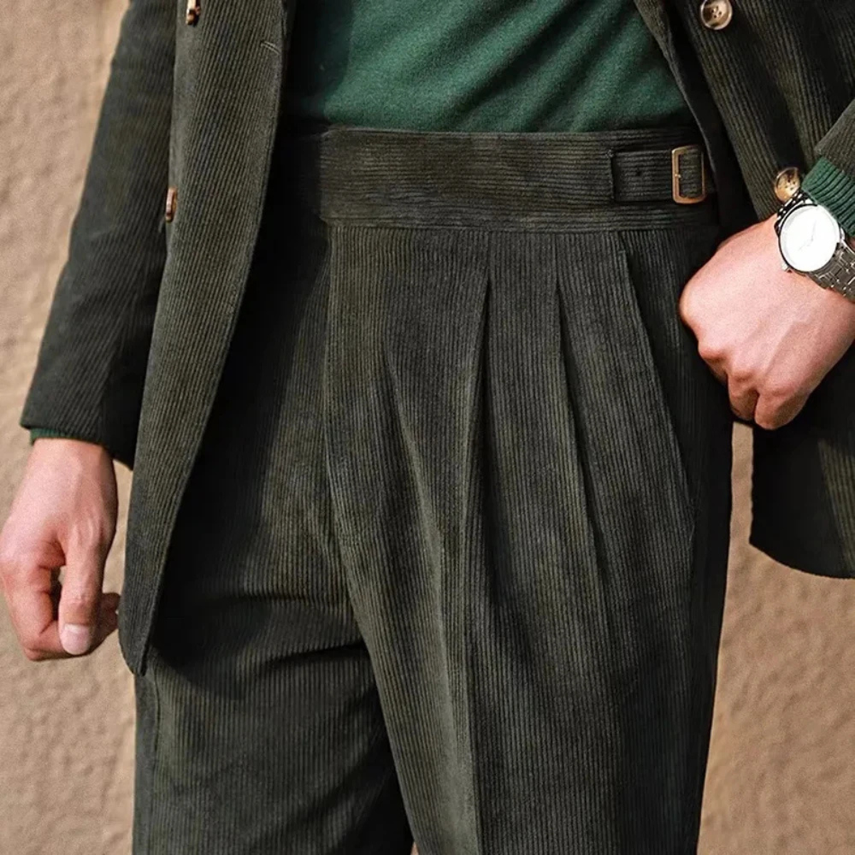 Green corduroy high-waisted pleated pants with side adjuster strap and belt loops