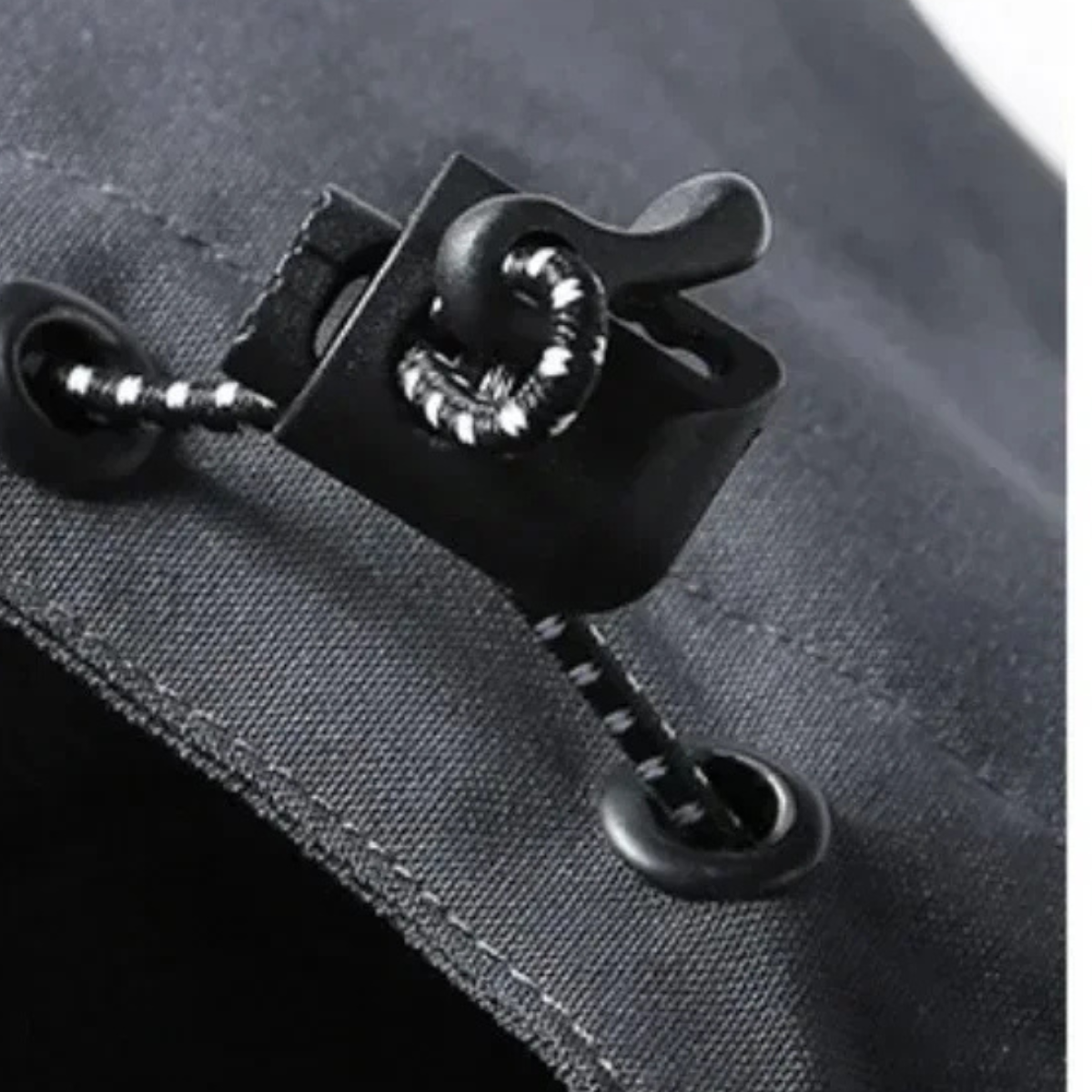 Black rain jacket toggle puller on waterproof zipper tape