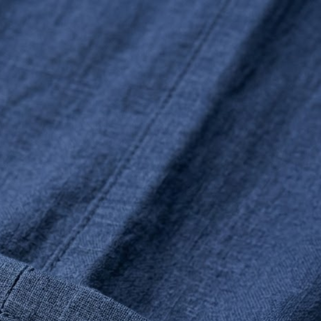 Hemp pants fabric close-up, light blue textured weave