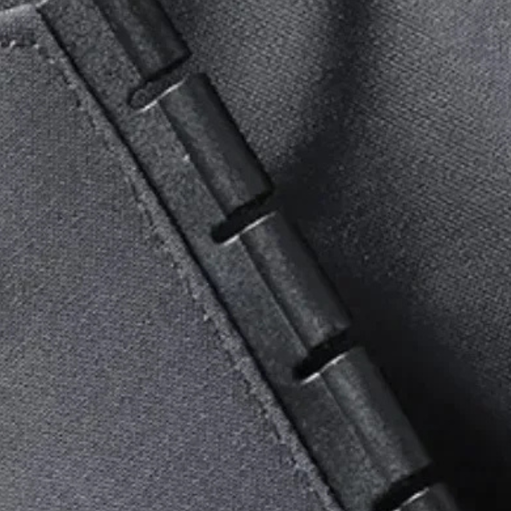 Black rain jacket zipper seam and pull detail on textured fabric