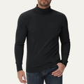 Men's black slim-fit cotton turtleneck sweater worn with jeans; ribbed cuffs.