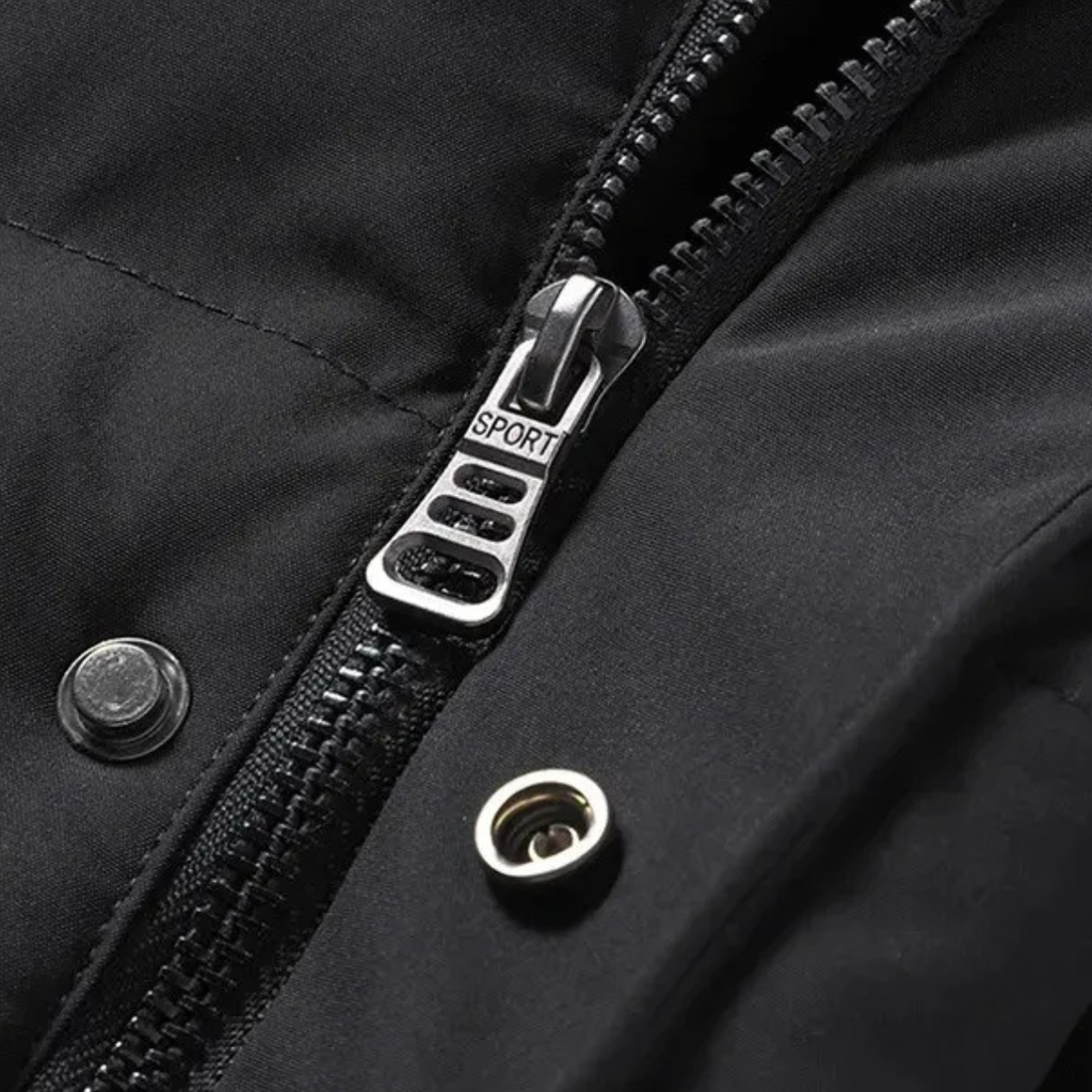 Black puffer jacket close-up of front zipper pull and snap button