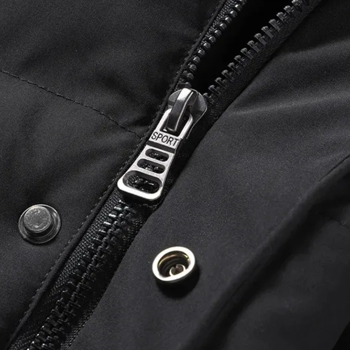 Black puffer jacket close-up of front zipper pull and snap button