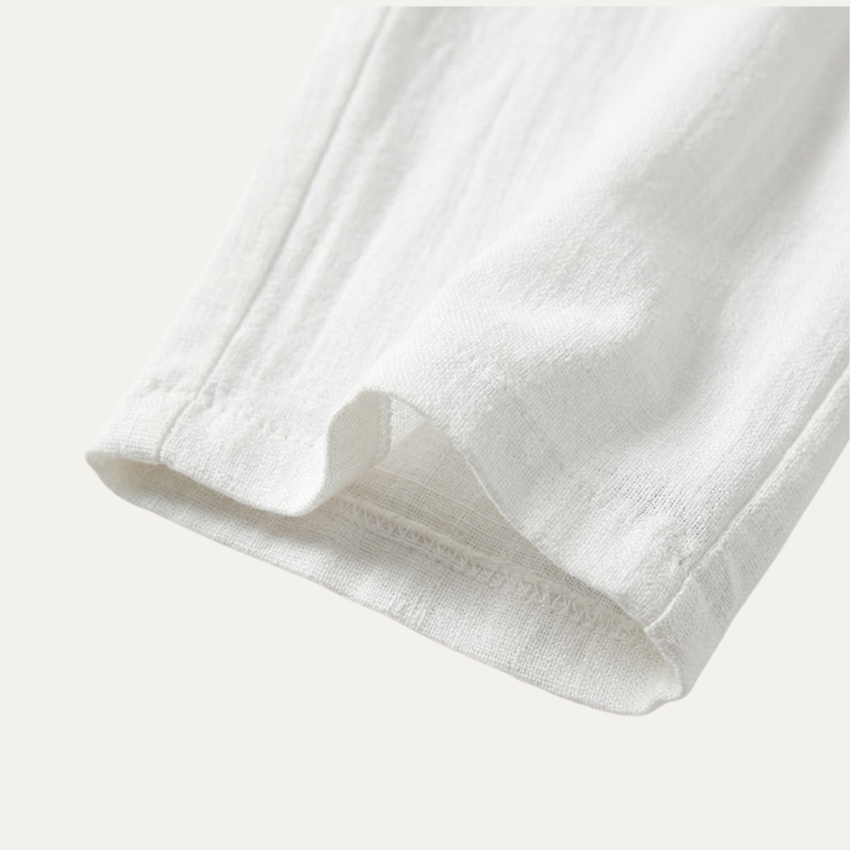 White cotton jogger pants close-up of hem and breathable fabric texture
