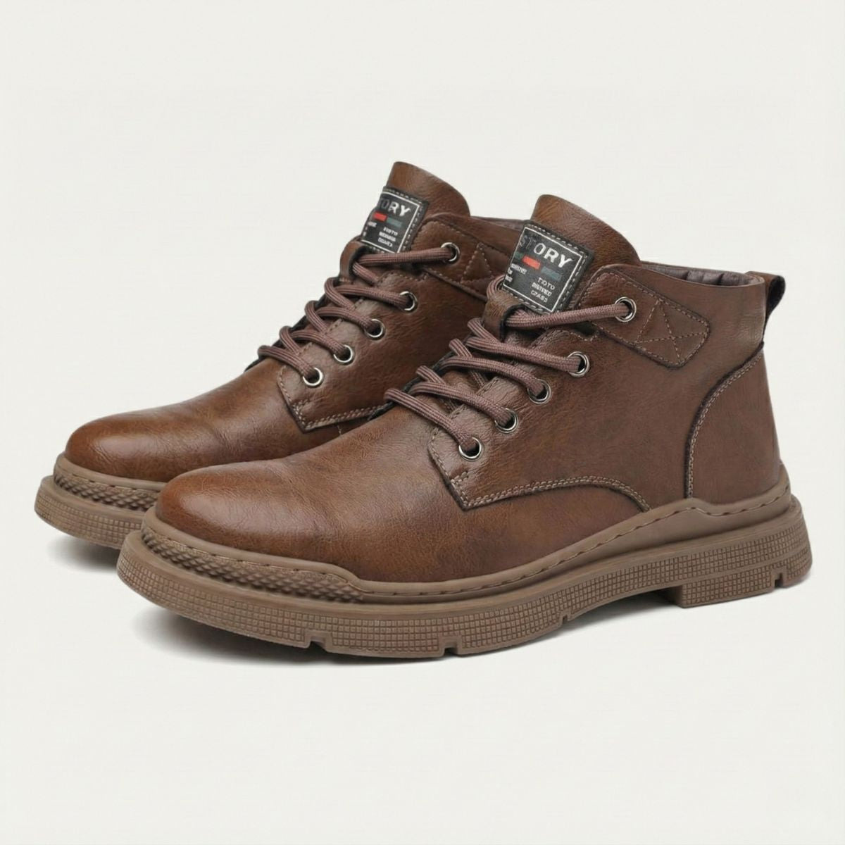 Brown leather lace-up ankle snow boots, padded collar, and treaded rubber sole