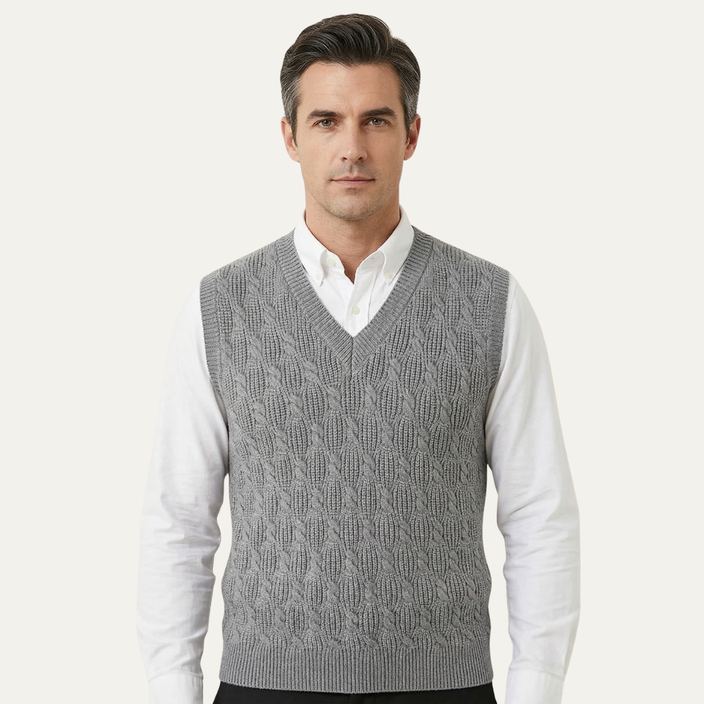 Men's gray textured knit V-neck sweater vest worn over a white button-down shirt