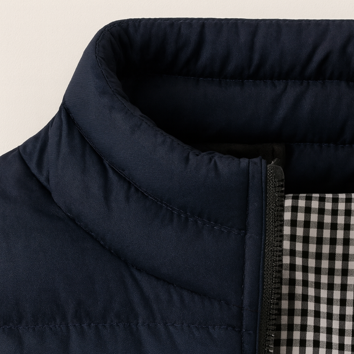 Navy puffer vest collar with stand neck and zip-front, check lining visible