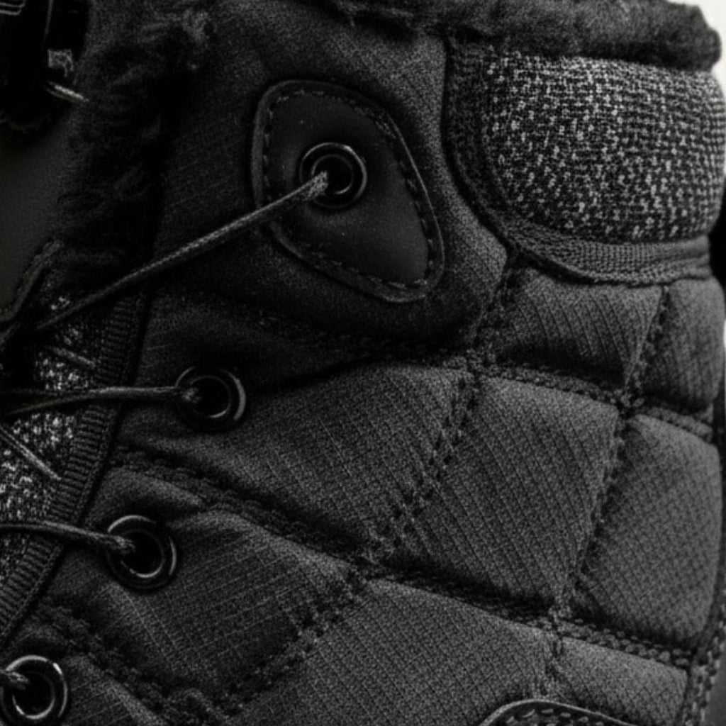 Men's black snow boot close-up: quilted upper with lace eyelets