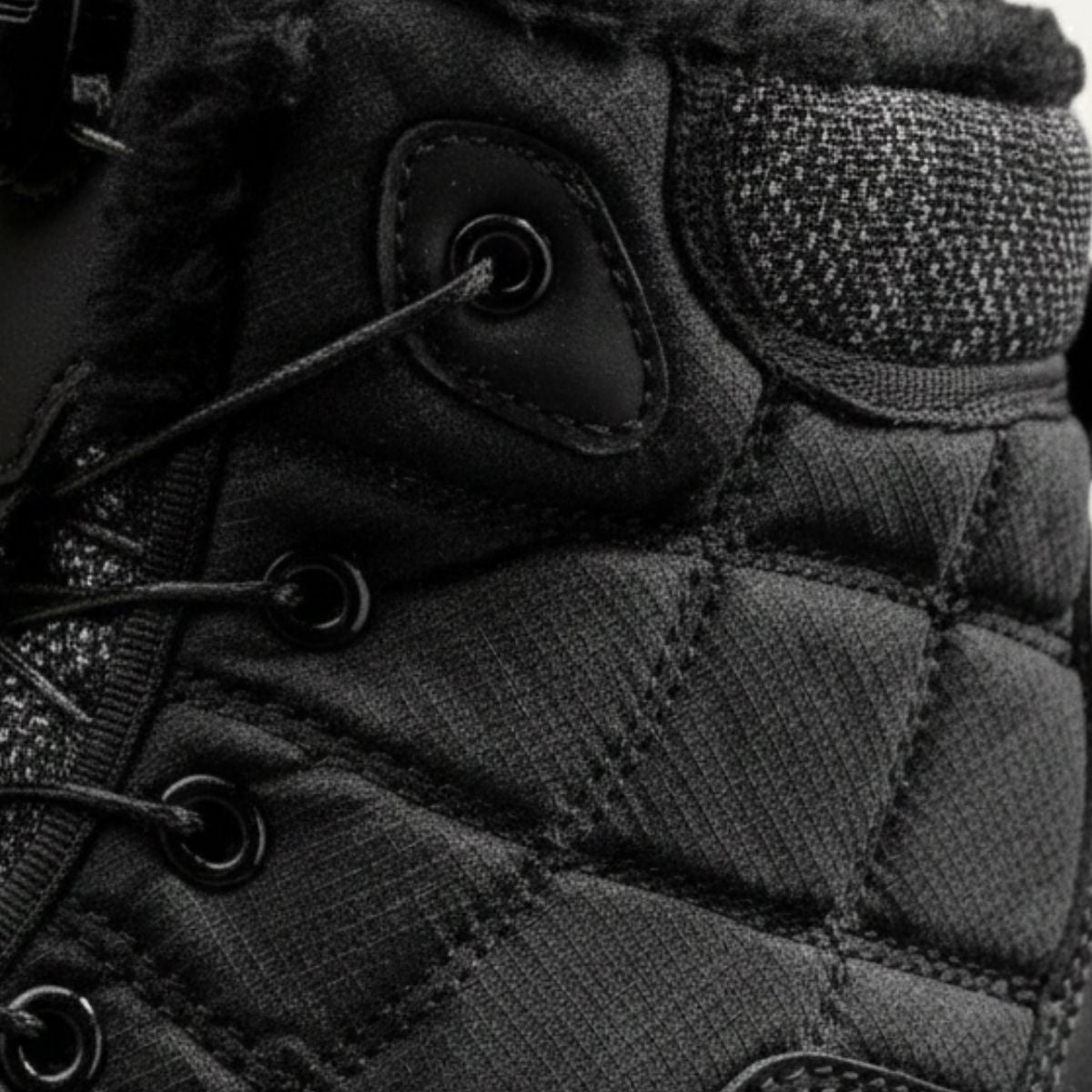 Men's black snow boot close-up: quilted upper with lace eyelets
