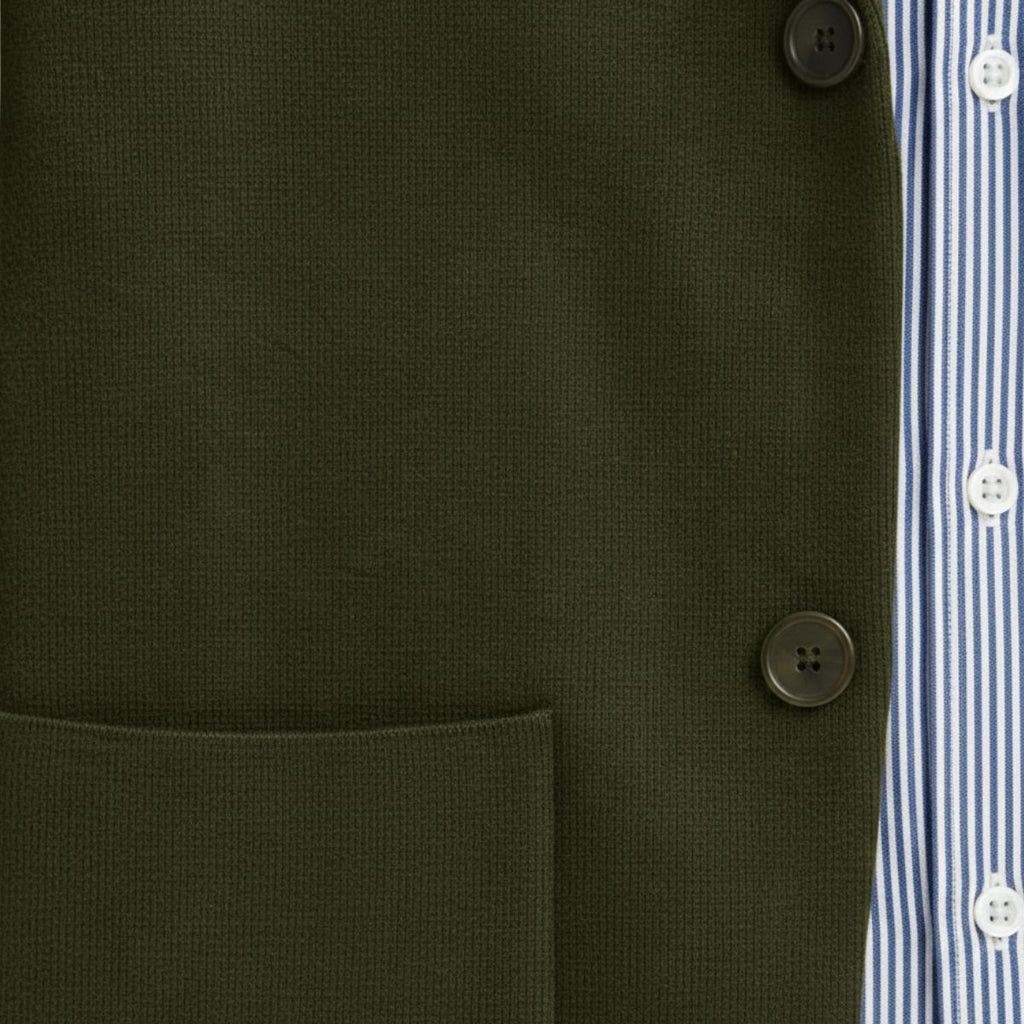 Military green cotton blazer front with four-button closure and chest welt pocket