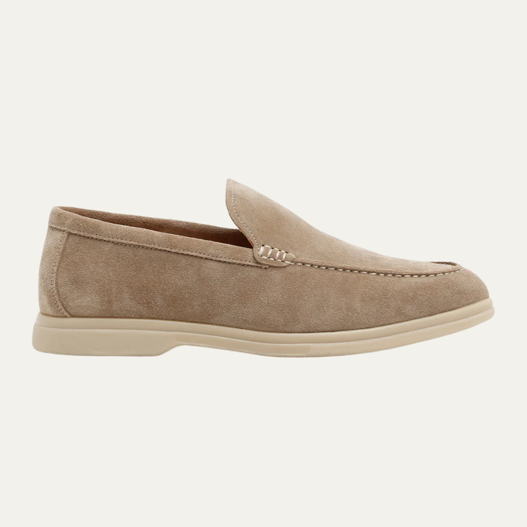 Beige suede slip-on loafers with moccasin stitching and low white rubber sole
