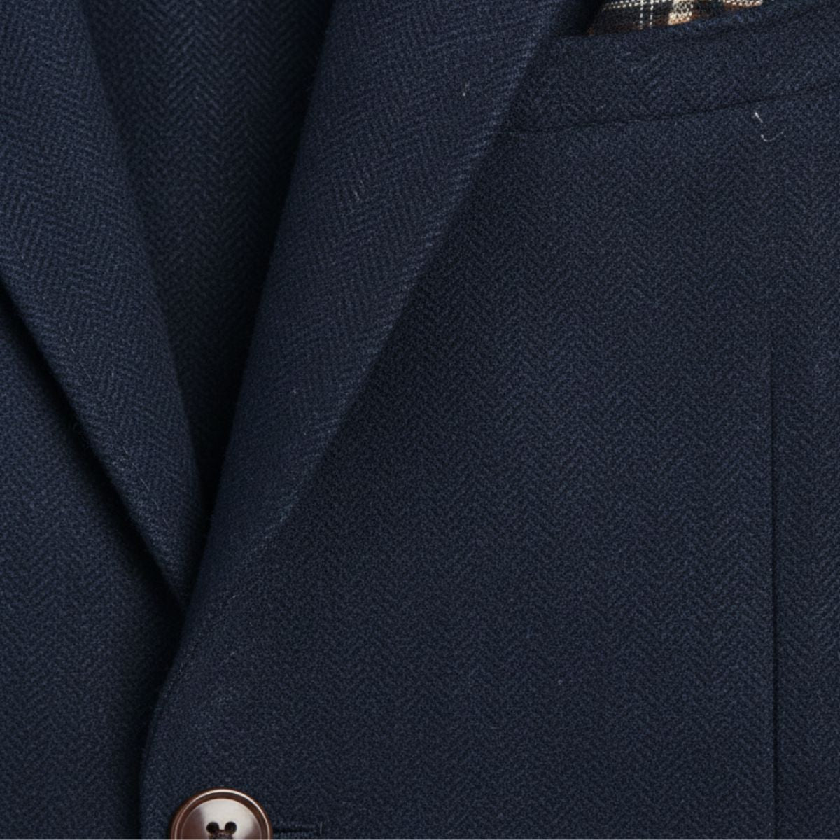 Navy blue herringbone wool blazer with single-breasted front and notch lapel