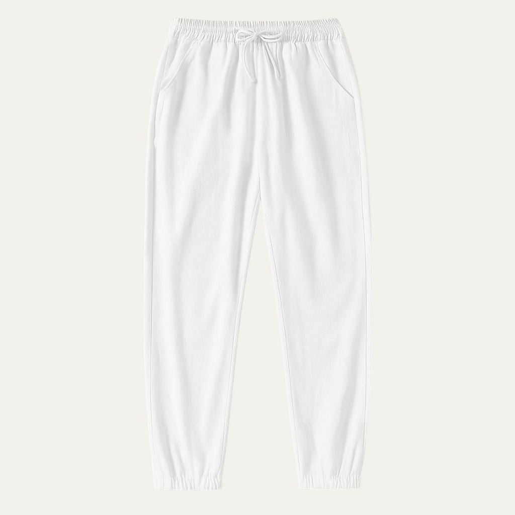 White cotton jogger pants with elastic waist, drawstring, and cuffed hems