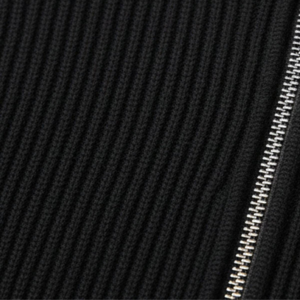 Black ribbed knit quarter-zip sweater close-up with zipper teeth