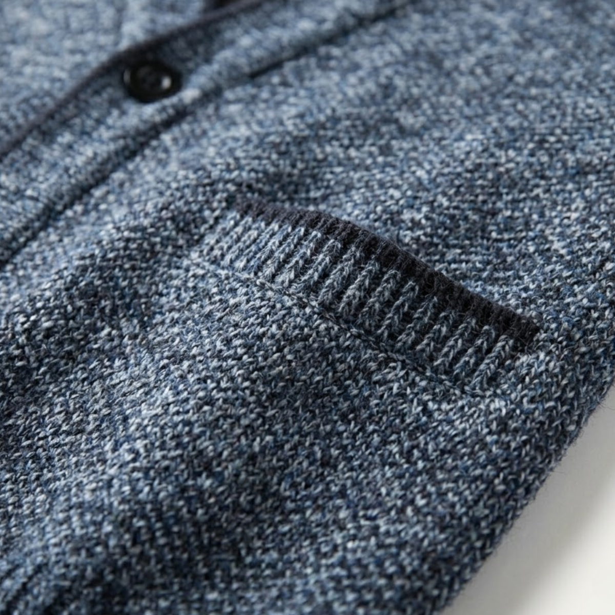 Blue heather knit fabric close-up with ribbed cuff and curved hem stitch details