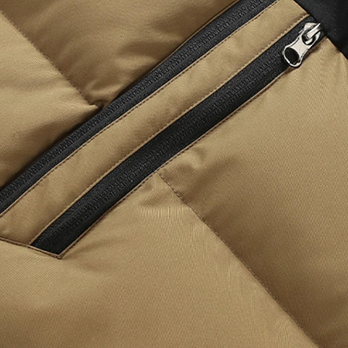 Khaki puffer vest detail: black zipper track with upper zip pocket
