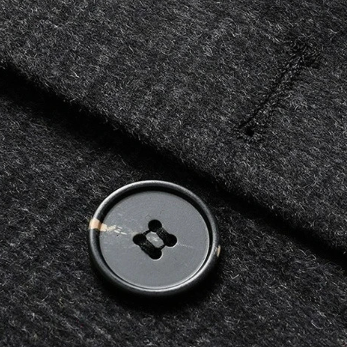 Dark gray wool-blend fabric with round black button detail