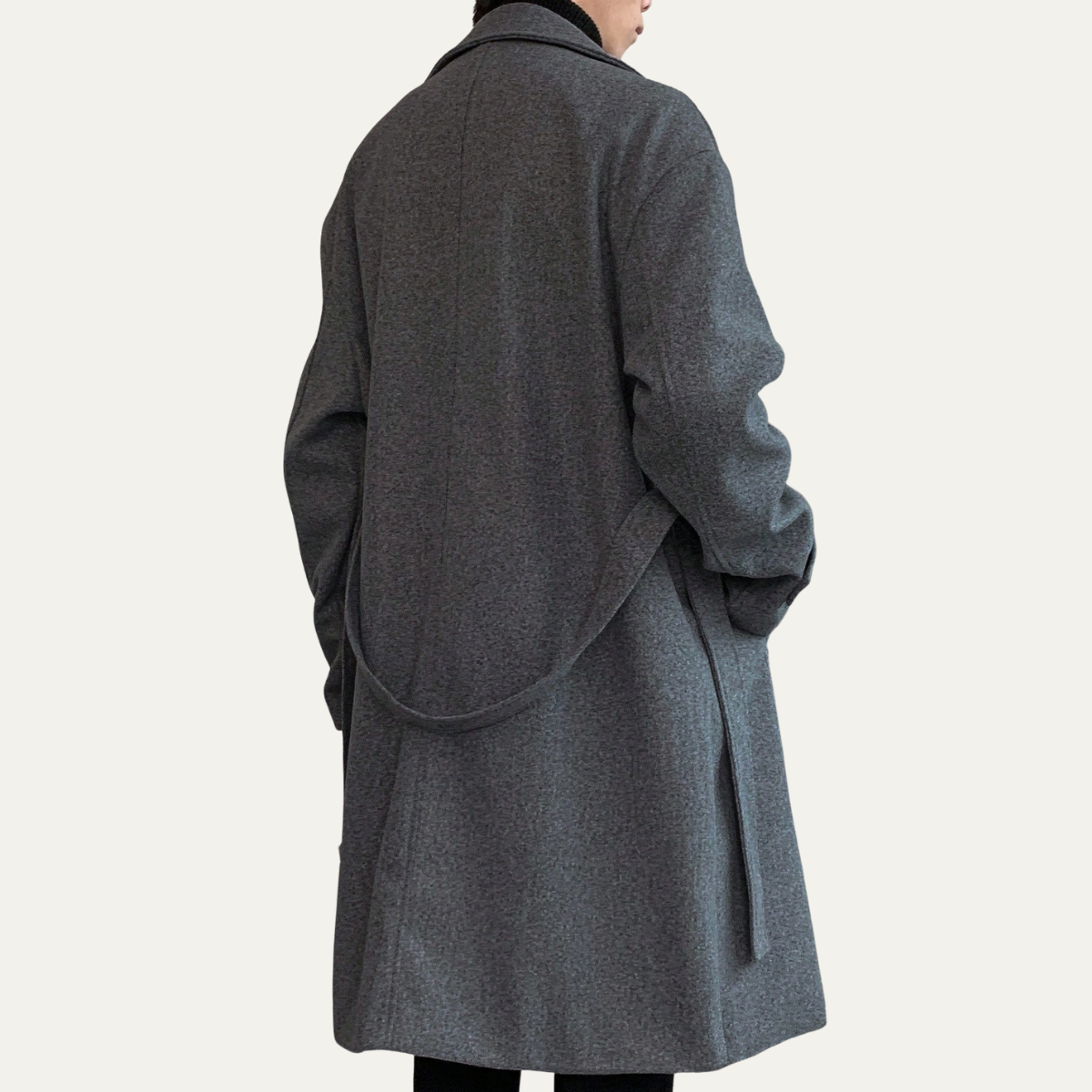 Gray wool overcoat back view with draped back and belt detail