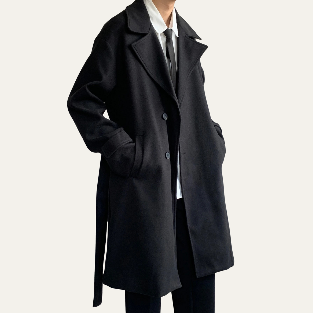 Black wool overcoat angled front with pointed lapels and button closure