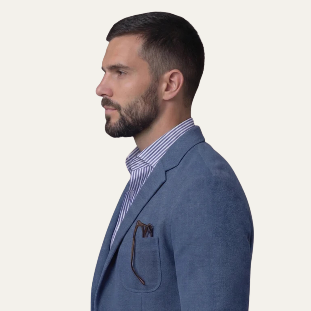 Men's lightweight slim-fit blazer in blue, side profile with welt chest pocket.