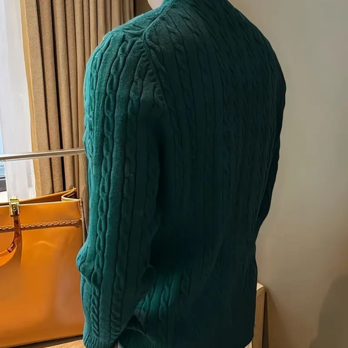 Men's green cable-knit crewneck sweater, side view with long sleeves