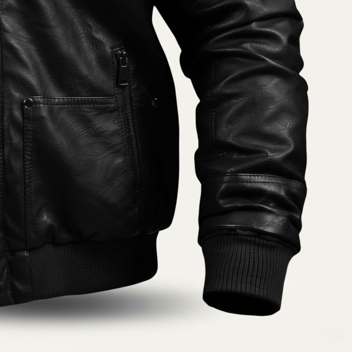 Men's black leather bomber jacket sleeve with ribbed cuff and side pocket