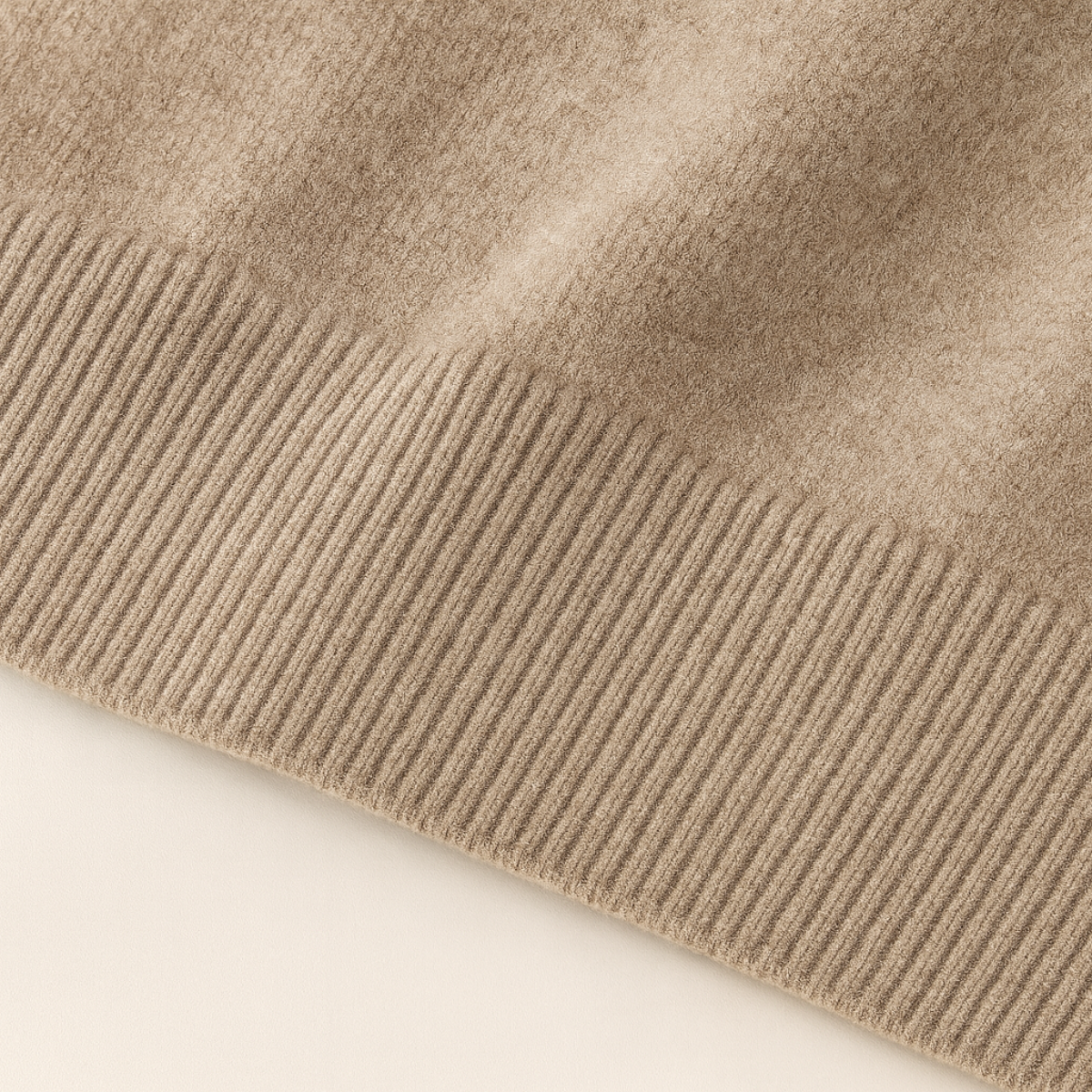 Beige wool sweater sleeve cuff with ribbed knit trim