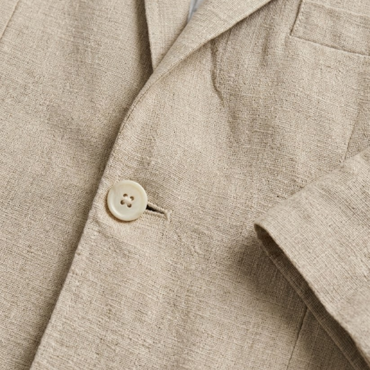 Close-up of khaki blazer fabric texture and round button on the front