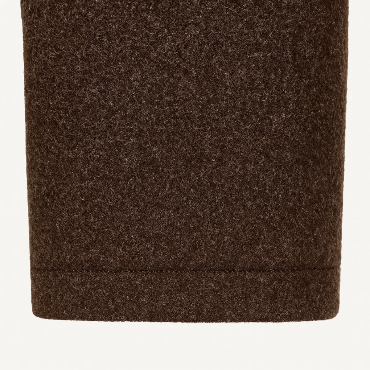 Brown wool-blend coat hem with clean stitched finish