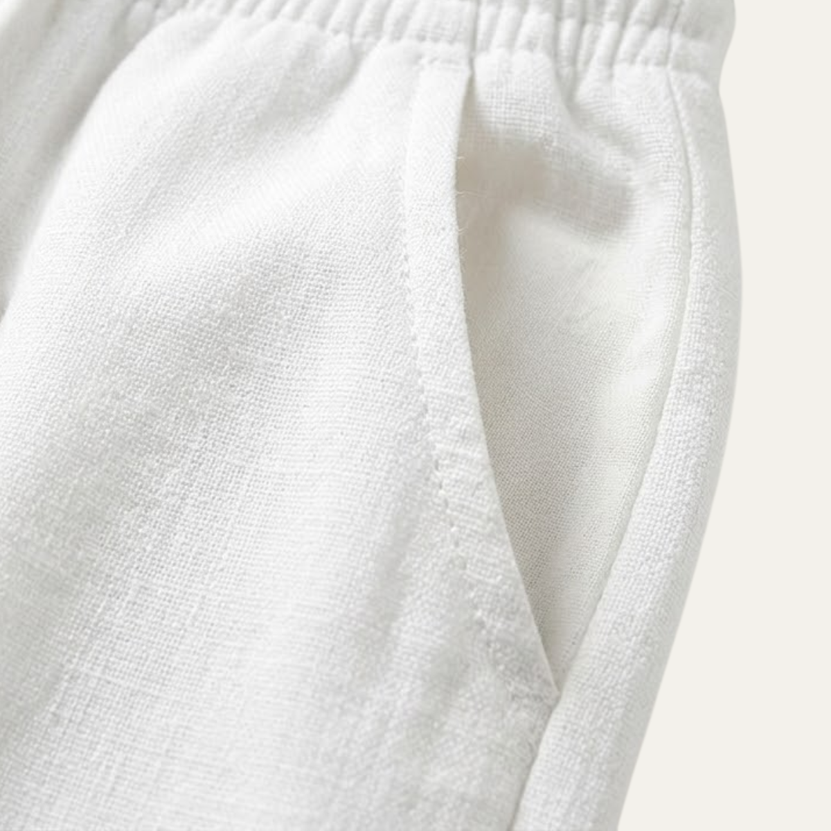 White cotton jogger pants close-up of elastic waistband and drawstring tie