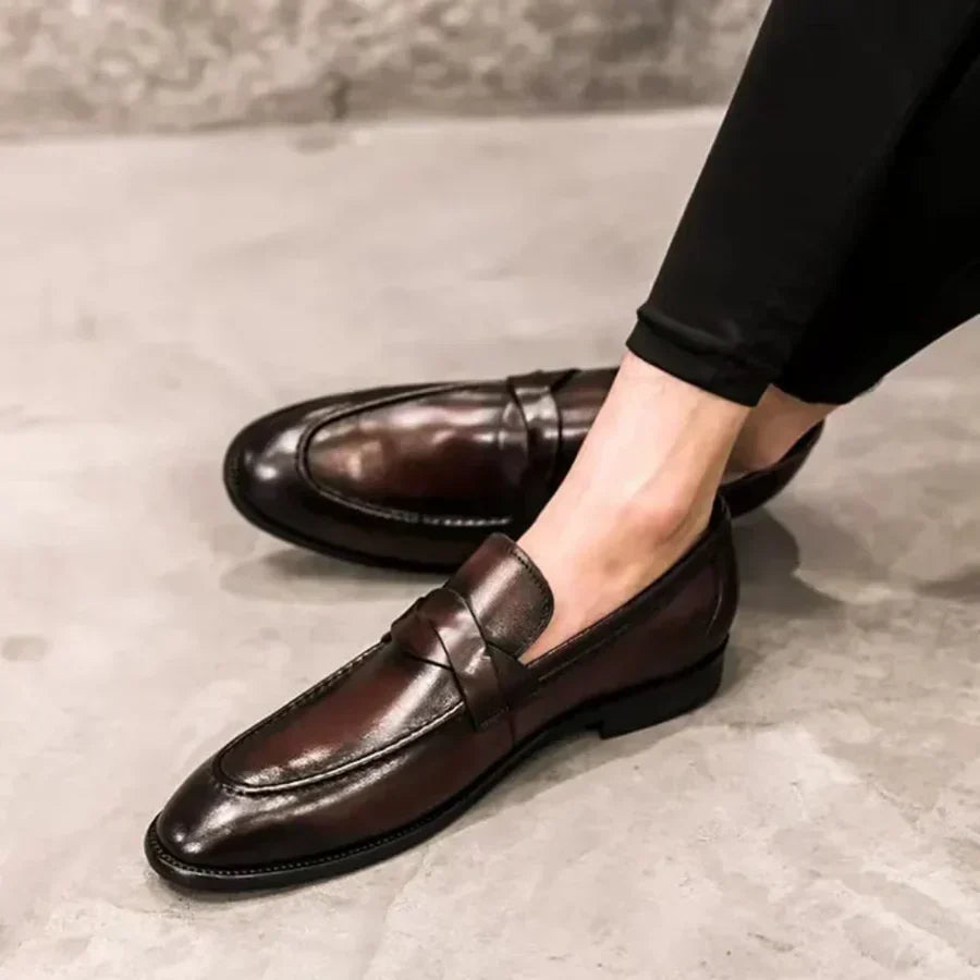 Brown leather penny loafers with glossy finish and penny strap detail