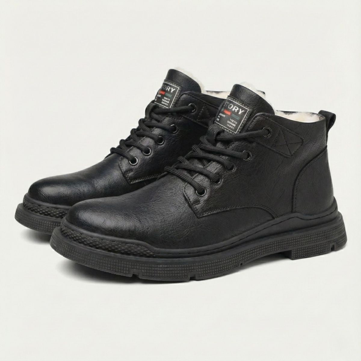 Black leather lace-up ankle snow boots, padded collar, and treaded rubber sole