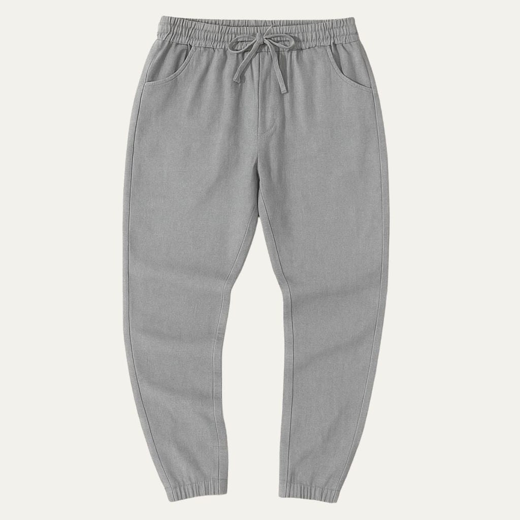 Gray cotton jogger pants with elastic waist, drawstring tie, and cuffed hems