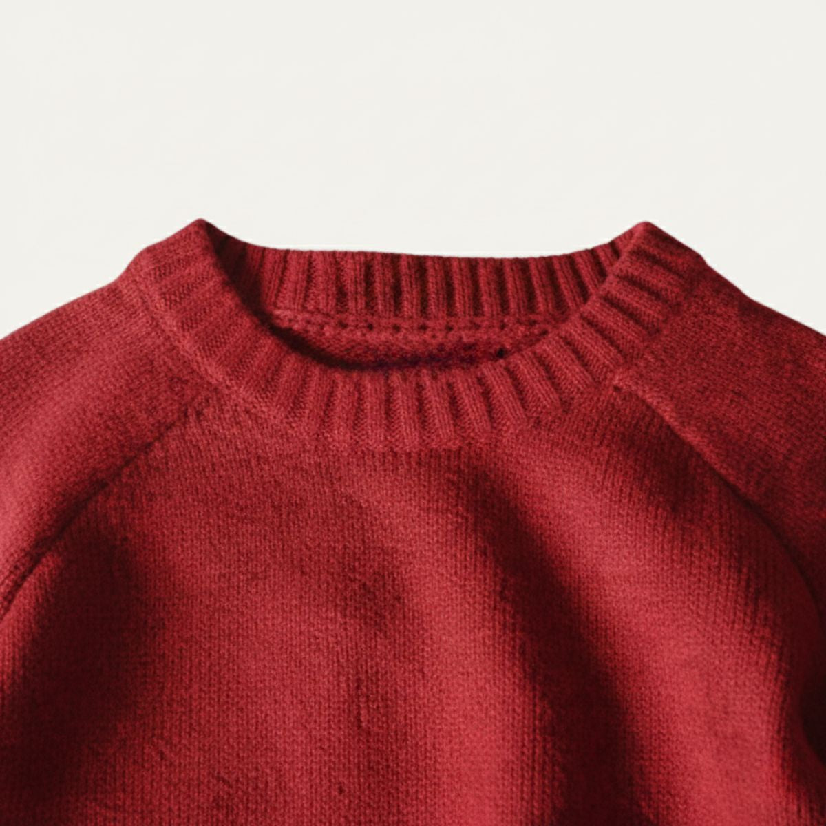 Red knit sweater neckline with ribbed crew collar and textured knit