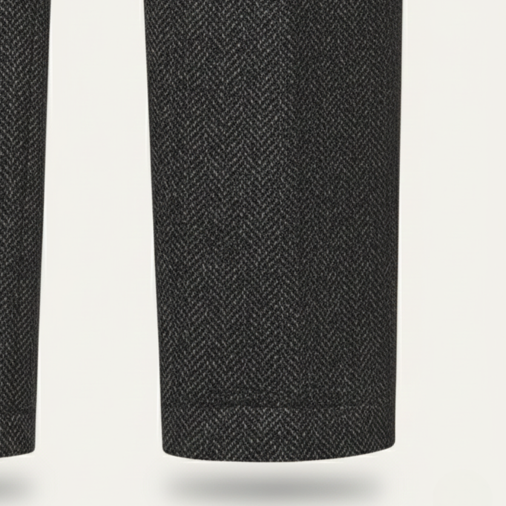 Dark gray herringbone tweed suit pants leg close-up