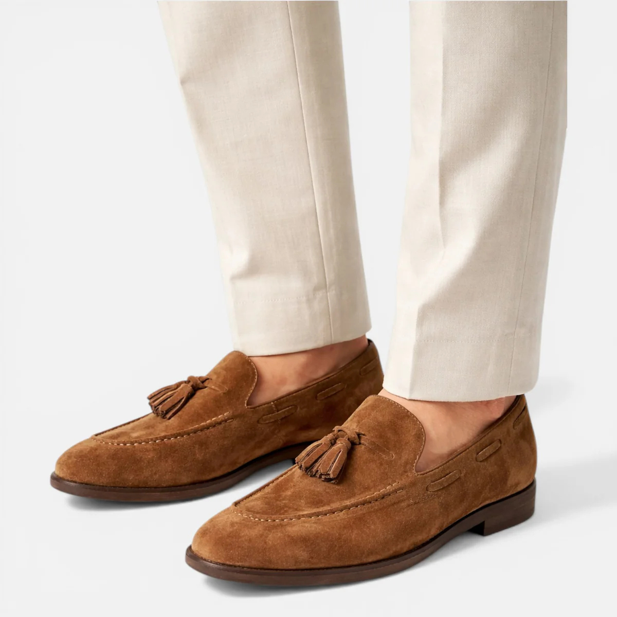 Men's faux leather tassel loafers in tan-brown worn with light pants