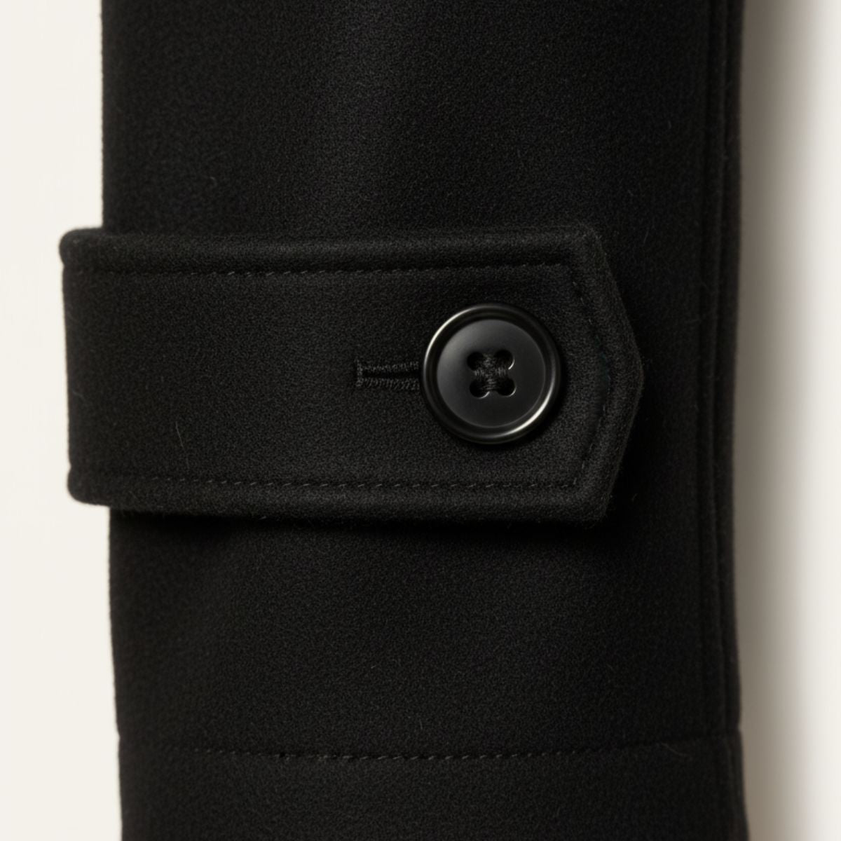 Black wool-blend pea coat cuff with buttoned strap detail