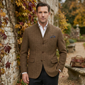 Brown herringbone wool blazer with notch lapel, chest pocket, and buttoned front.