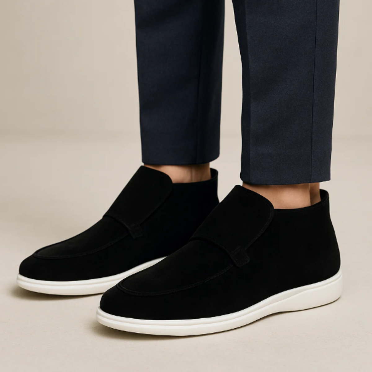 Men's black suede slip-on loafers with moc-stitch seam and white rubber sole.